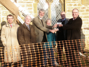 Handing over a cheque to Director Matthew Saunders in 2011