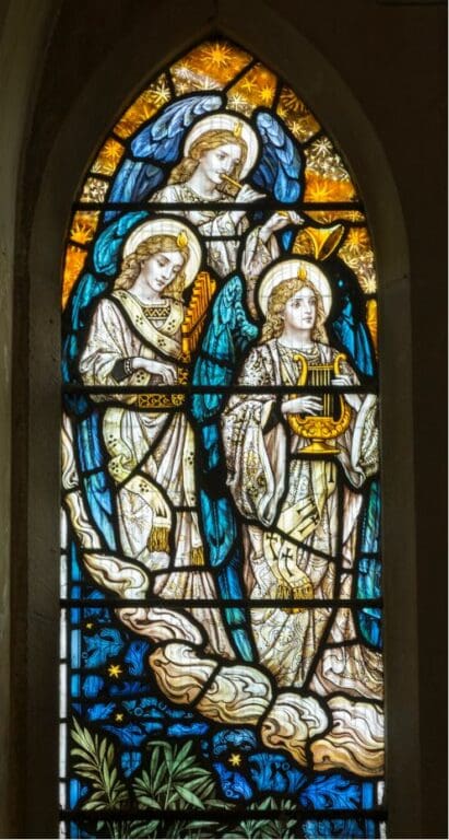 Stained glass window at St. Cynhaearn's depicting angels making the music of the heavens, by Powell & Sons