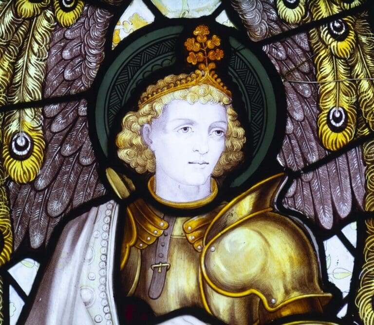 Colourful stained glass of an angel in armour with big wings